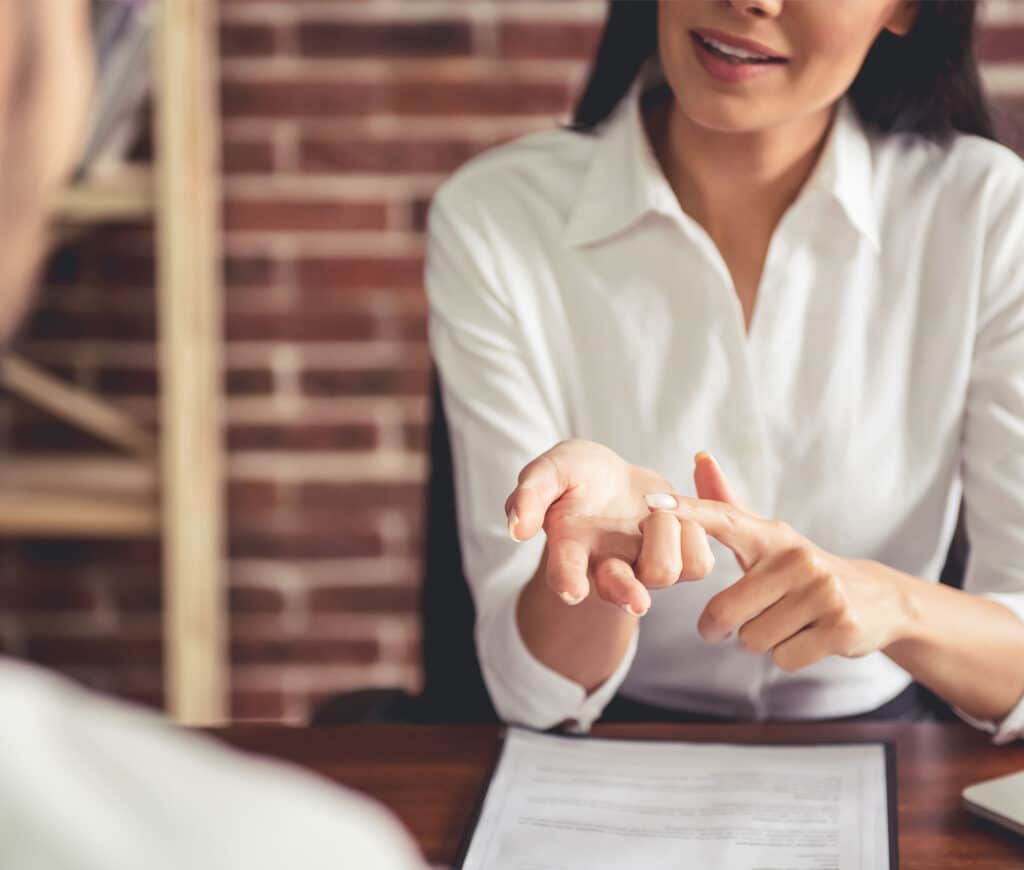 woman talking over paperwork with patient.