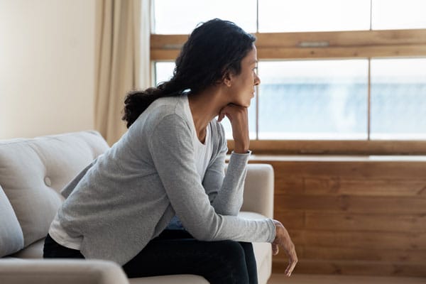 anxious woman at therapy appointment looking out window