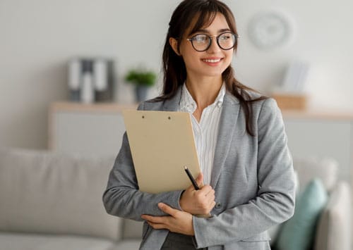 therapist holding clipboard during an appointment.