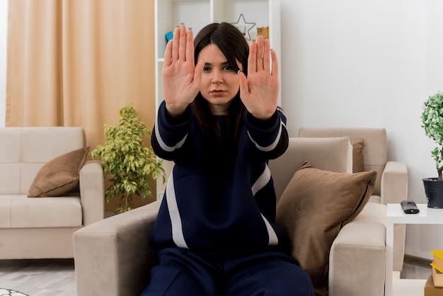 female holding ten fingers up to represent the 10 warning signs of anxiety