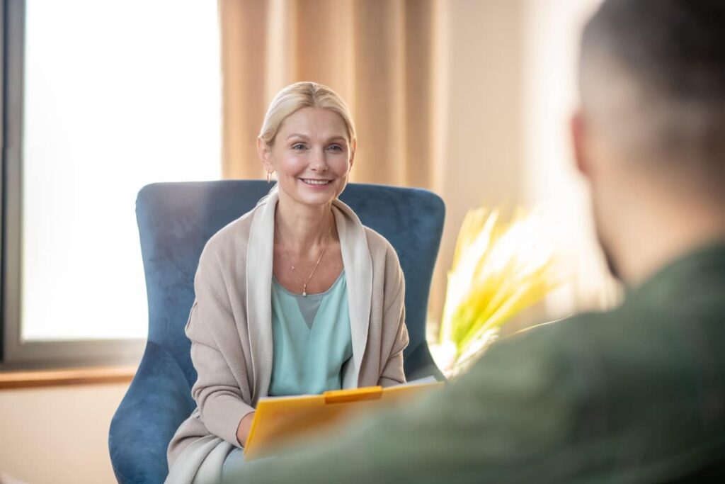 therapist talking to patient during a therapy appointment.