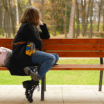 person sitting on bench, looking away from the camera, dealing with ocd and anxiety at the same time