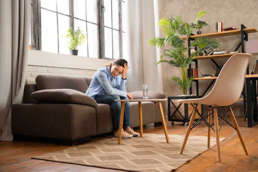 woman sitting on a couch in a psychologist office, wondering about bipolar emotions