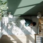 Person staying in bed all day struggling with depression and sleep problems