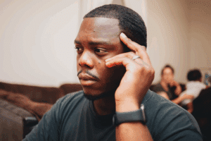 man with hand on head, wondering if he is experiencing intuition vs anxiety