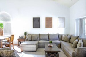 Bright living room with large comfortable couch next to coffee table