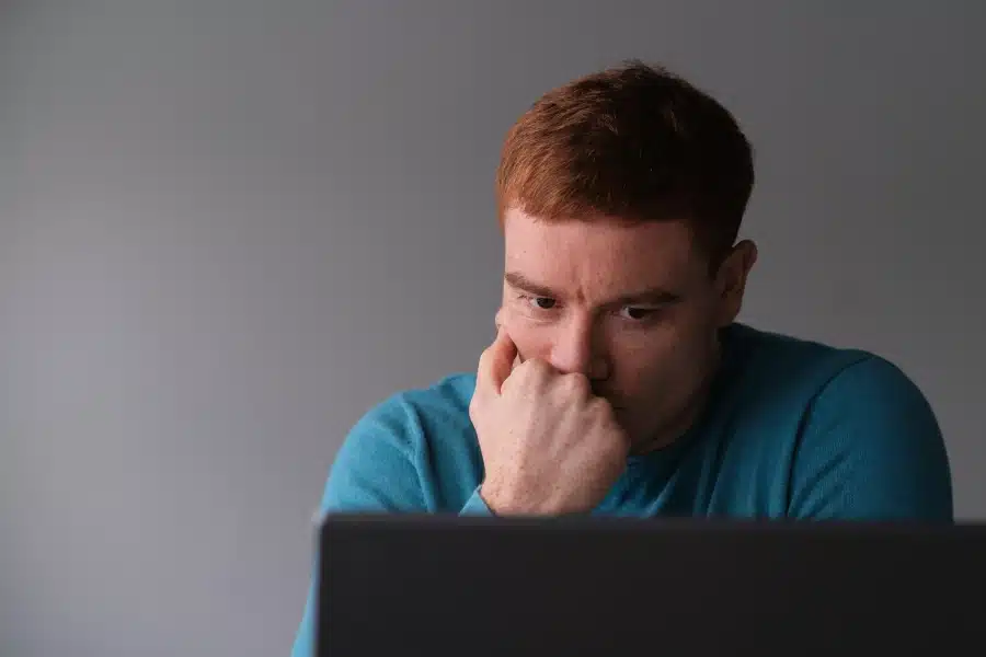 Person feeling low after job rejection and job search challenges