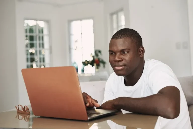 Man on laptop looking for online therapy in California