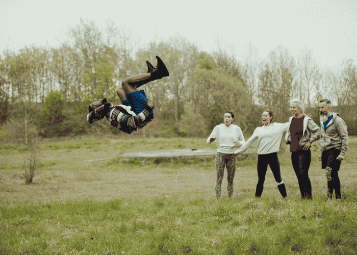Man doing a backflip showing off in front of his friends due to histrionic personality disorder in adults