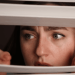 Woman looking out of the window looking worried due to paranoid personality disorder in adults