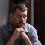 Depressed man at home wondering, is depression a mental illness?