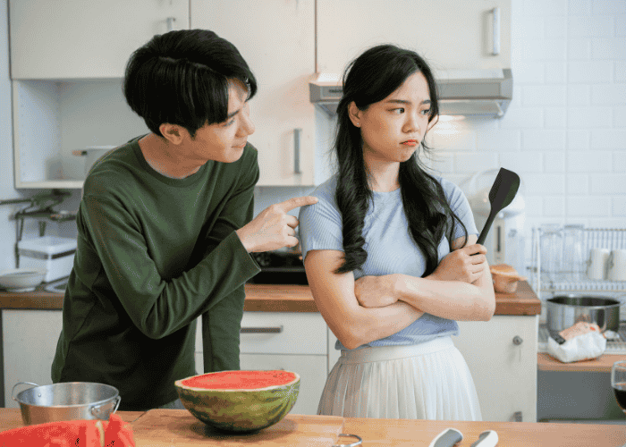 Man who has dependent personality disorder in adults poking his girlfriend while she looks upset