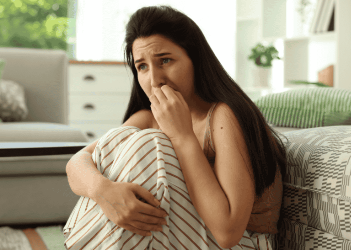 Woman biting her nails and trying to manage panic attacks in adults