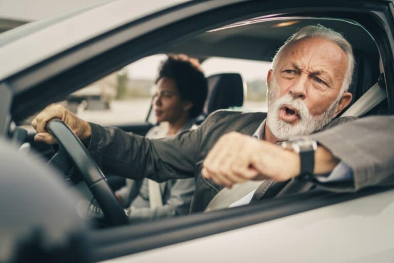 Shot of two successful multi-ethnic business people traveling by car, with a man wondering "what can you do to reduce road rage?"