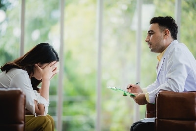 Mental health professional discussing OCD treatment costs with patient