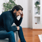 Man with his head in his hands, in need of Disinhibited Social Engagement Disorder (DSED) Treatment