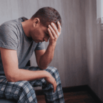 Man with head in hands needing schizoaffective disorder treatment