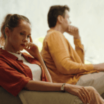Couple looking away from each other after an argument, in need of reactive attachment disorder (RAD) treatment