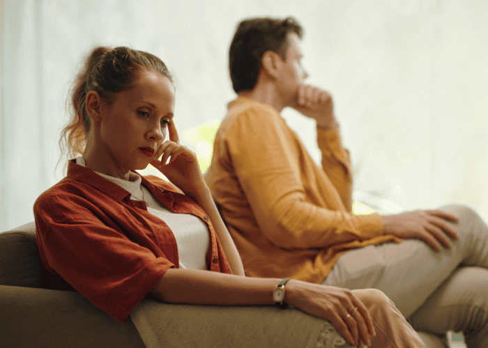 Couple looking away from each other after an argument, in need of reactive attachment disorder (RAD) treatment