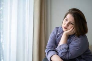 Sad,Plus,Size,Woman,Looking,Out,Window,Thinking,About,Life