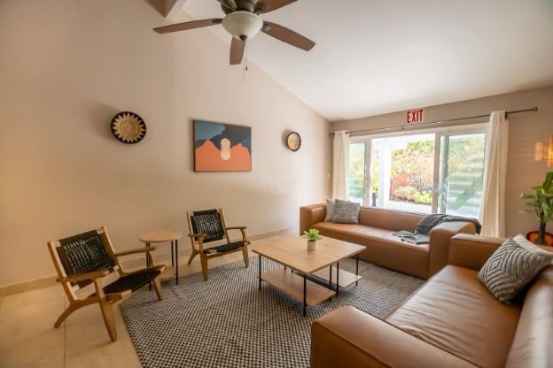 Modern living room with tan sofas | AMFM Treatment