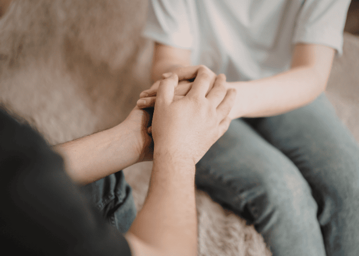 One person comforting another after learning about California's CARE act