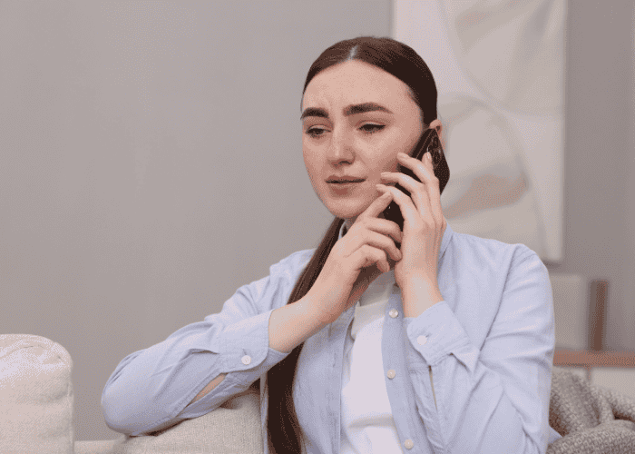 Woman on the phone, calling California LGBTQ+ crisis hotlines