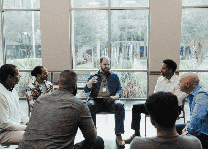 Men in a group therapy session after changes in Virginia behavioral health services law