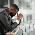 Man with his hands on his head feeling overwhelmed due to Washington's mental health parity rules