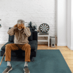 Woman sitting on an armchair with his hands on his neck managing chronic pain