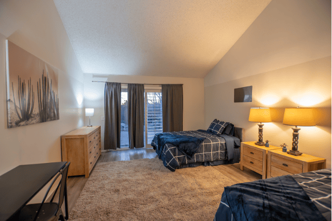 Modern bedroom with two beds | AMFM Treatment