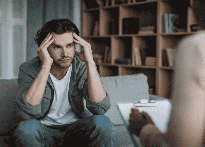 Man in a therapy session for mental health stigma reduction