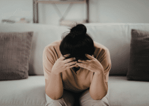 Woman with head in hands managing underrecognized signs of adhd in women