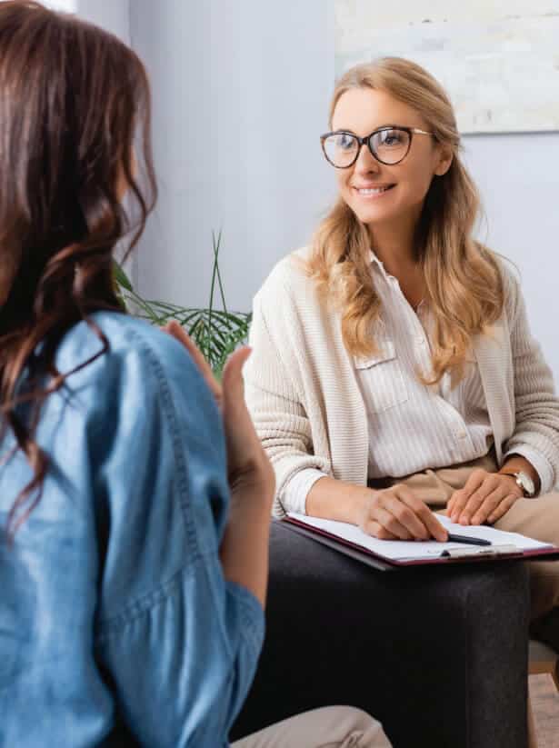 woman talking to woman with clipboard | AMFM Treatment