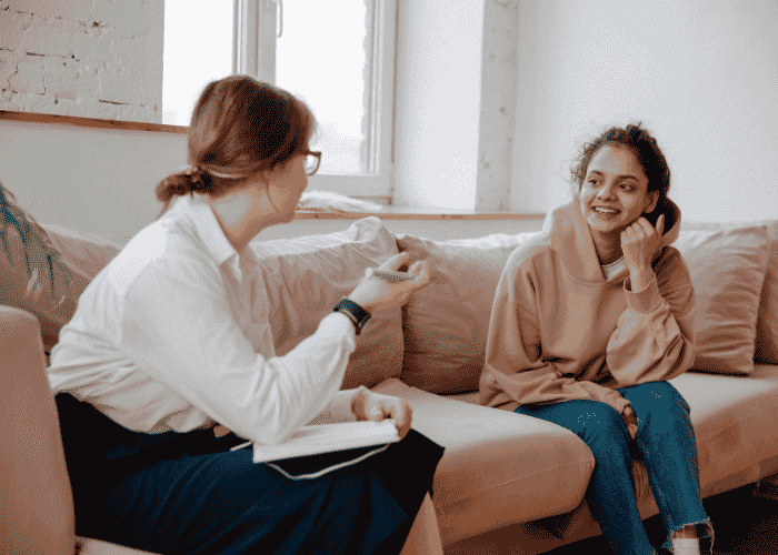 Multiracial woman smiling in therapy due to culturally competent therapist