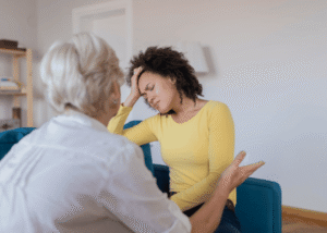 Multiracial woman in a therapy session, looking upset because she doesn't have a culturally competent therapist