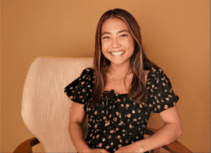 Female therapist smiling while sitting in chair